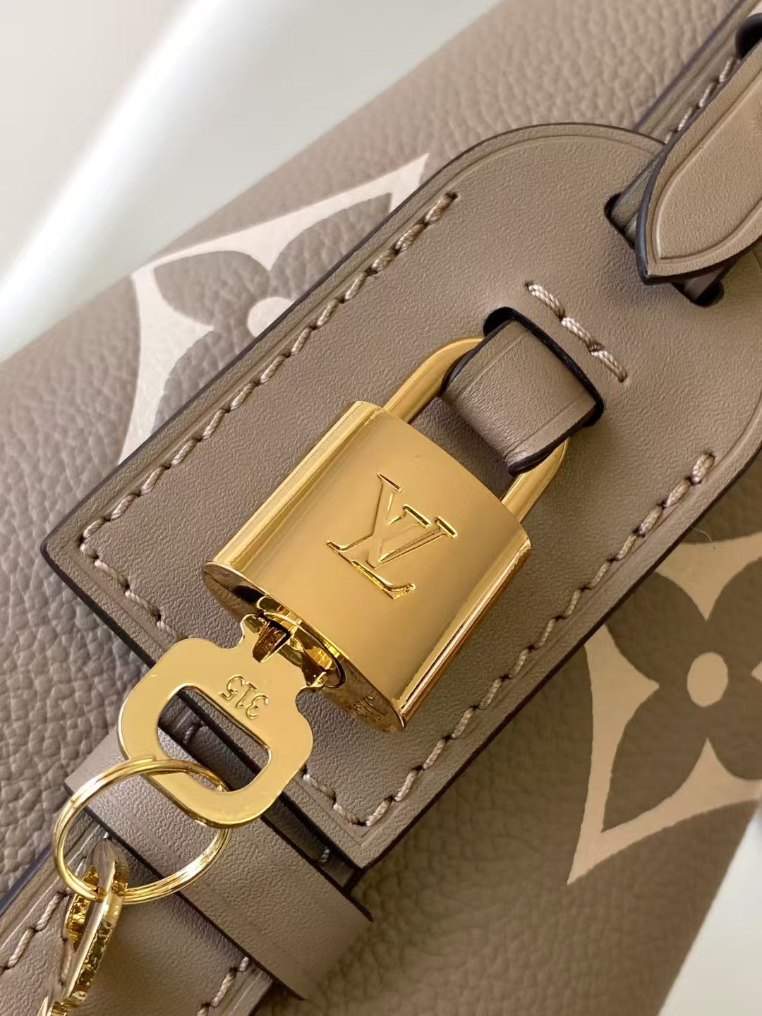 M40817 Bucket Shoulder Bag Monogram Embossed Grey Color.